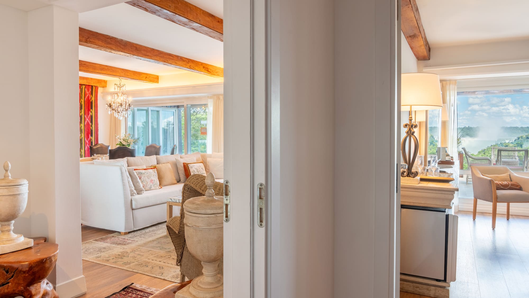 a room with a white couch and a large kitchen