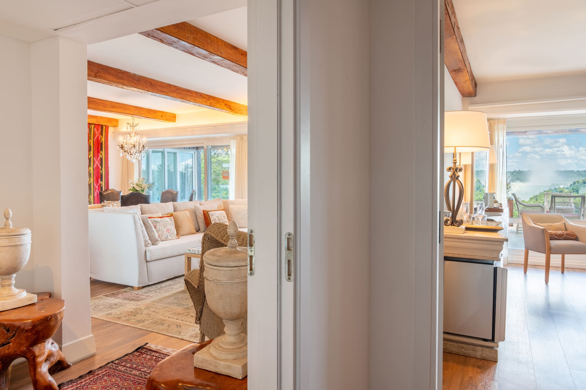 a room with a white couch and a large kitchen
