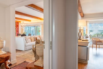 a room with a white couch and a large kitchen