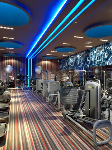 a room with exercise equipment and a blue and white wall