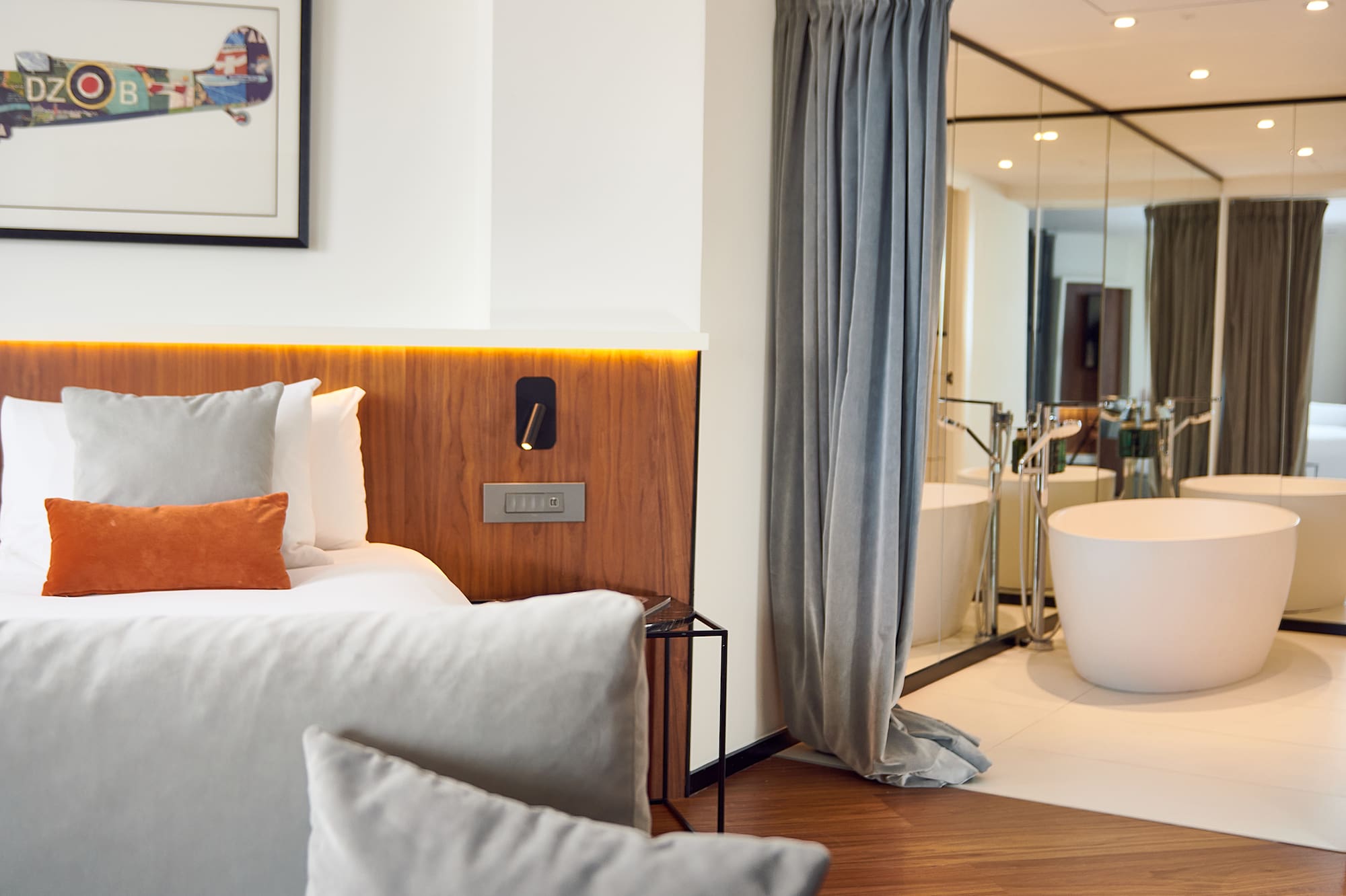 a bedroom with a bathtub and a bed