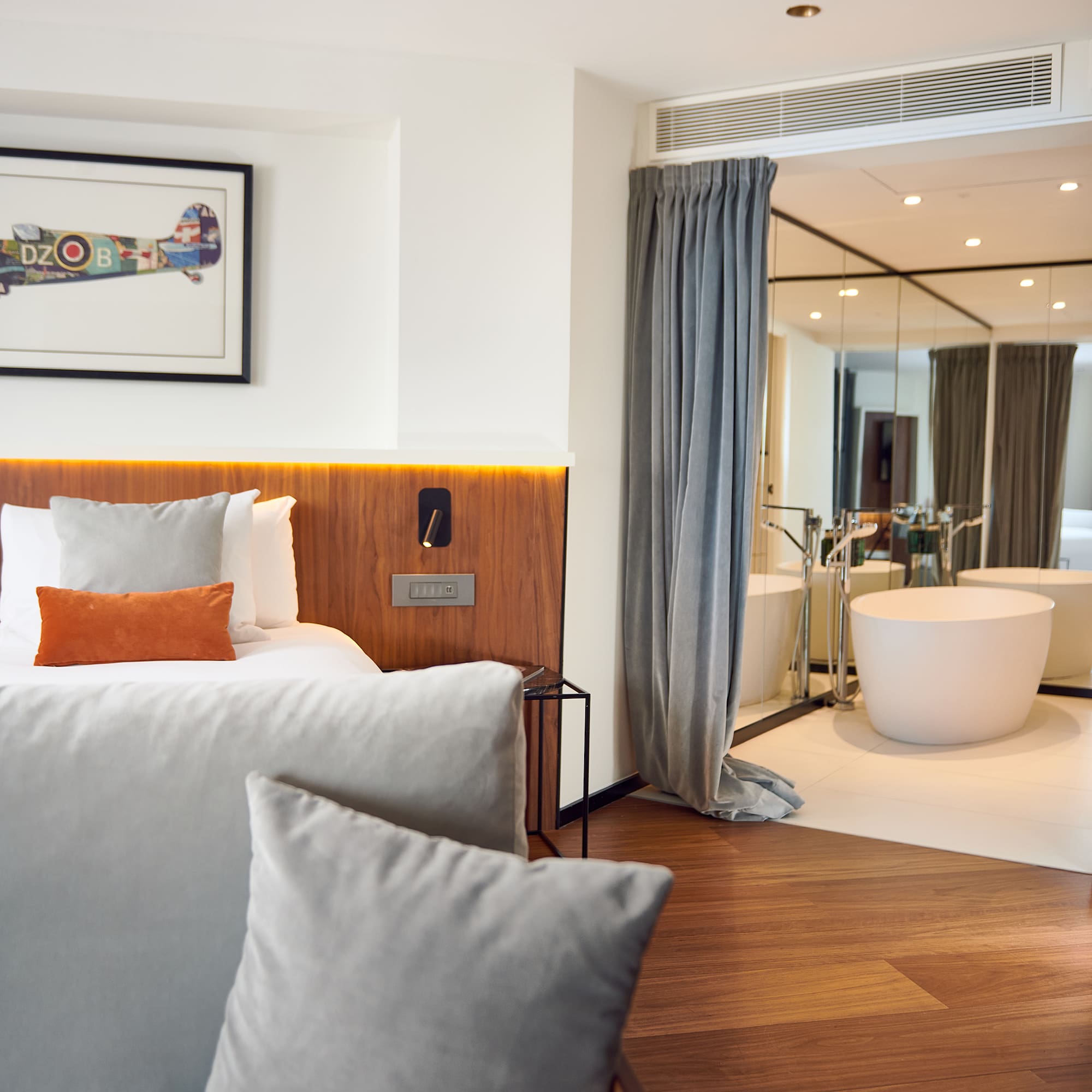 a bedroom with a bathtub and a bed