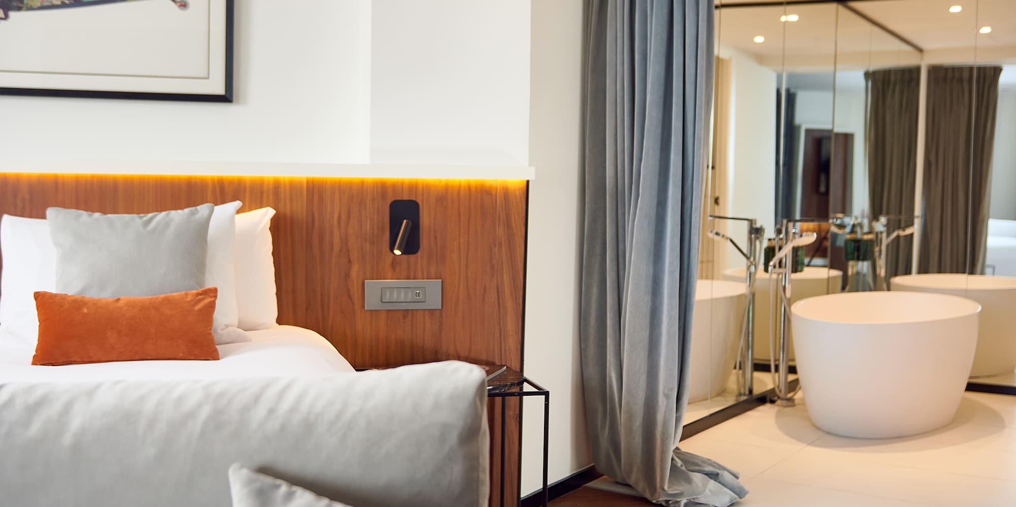 a bedroom with a bathtub and a bed