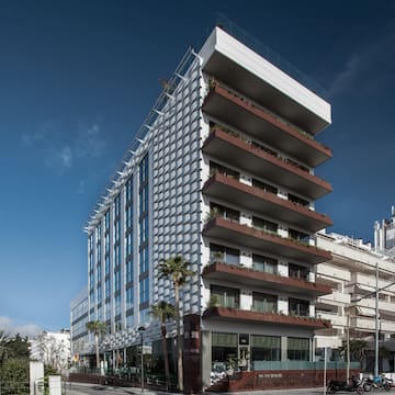 a building with balconies and palm trees