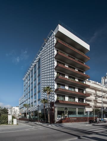 a building with balconies and palm trees