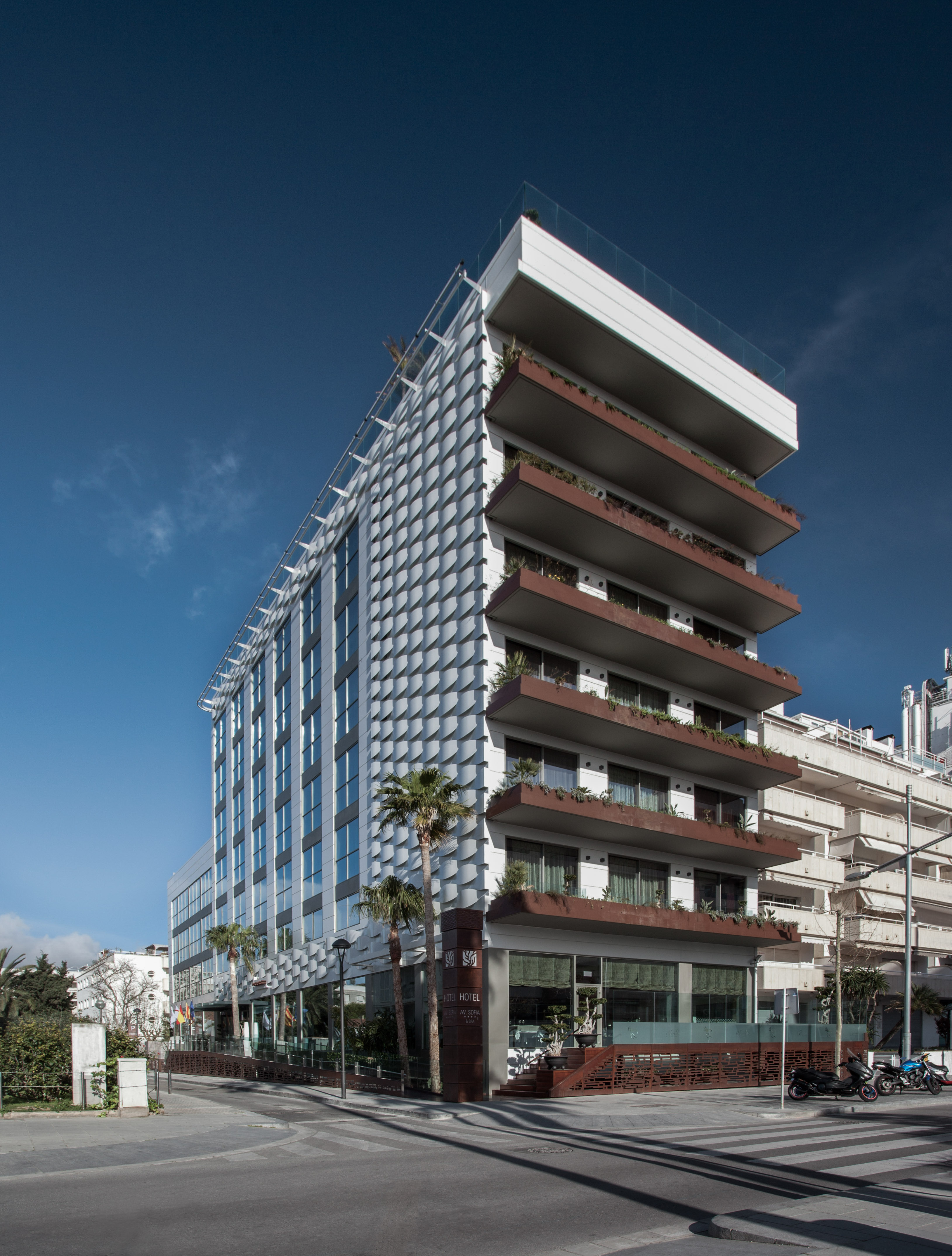 a building with balconies and palm trees