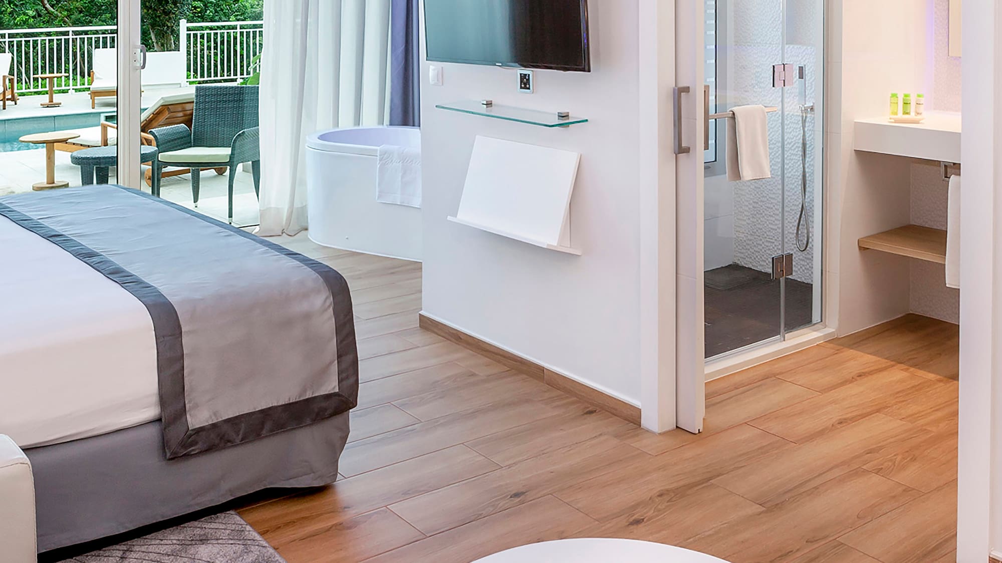 a room with a bed and a television