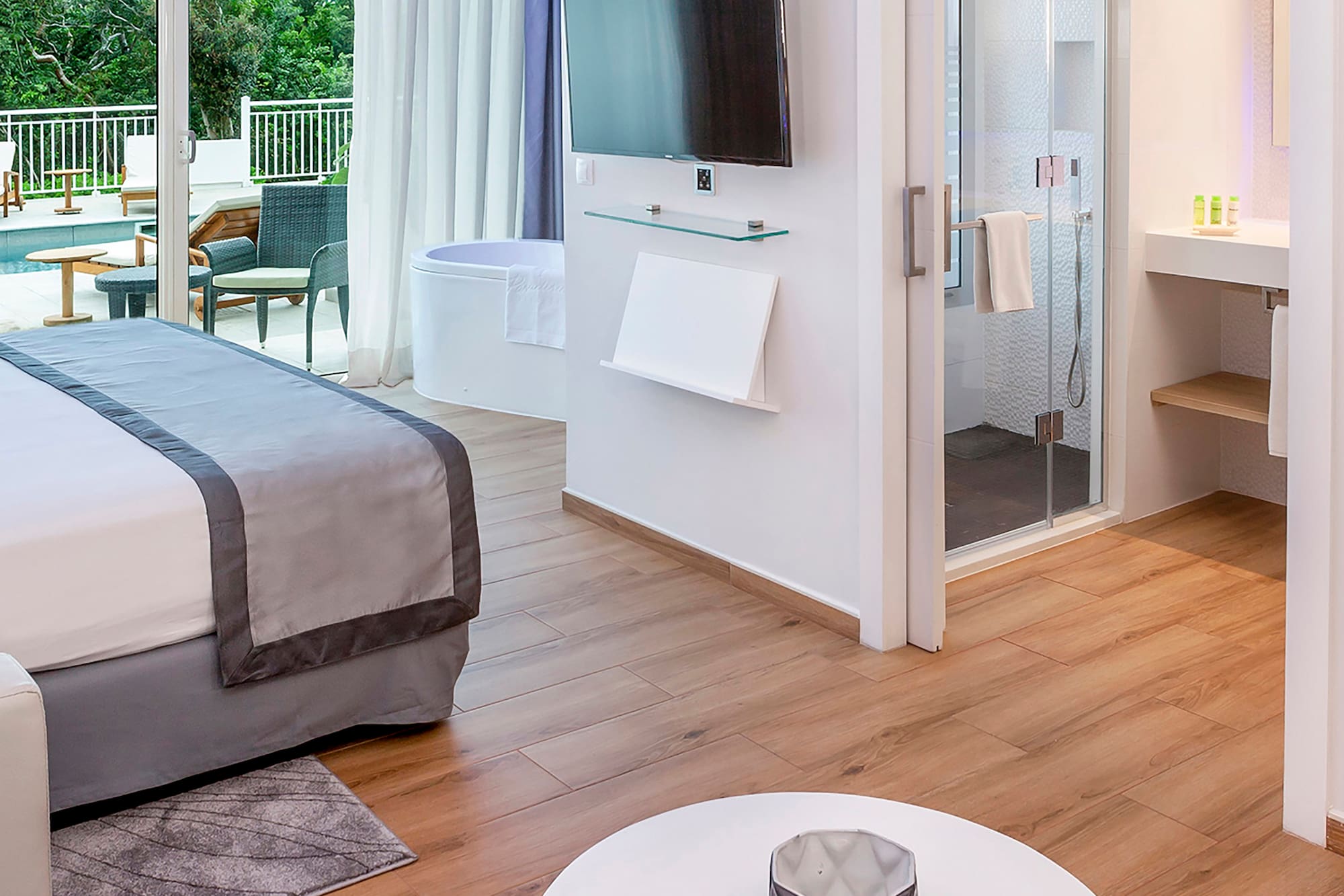 a room with a bed and a television