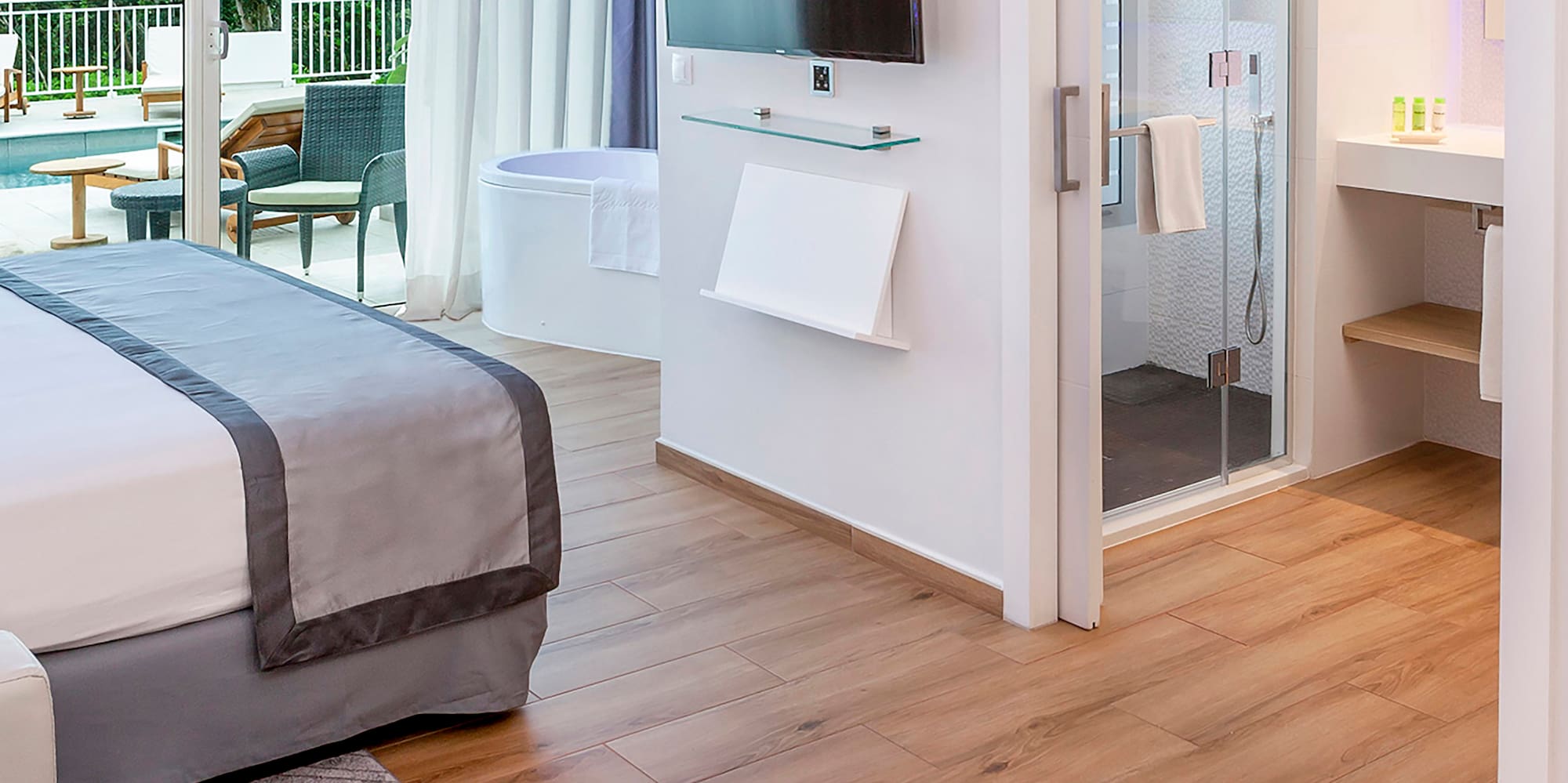 a room with a bed and a television