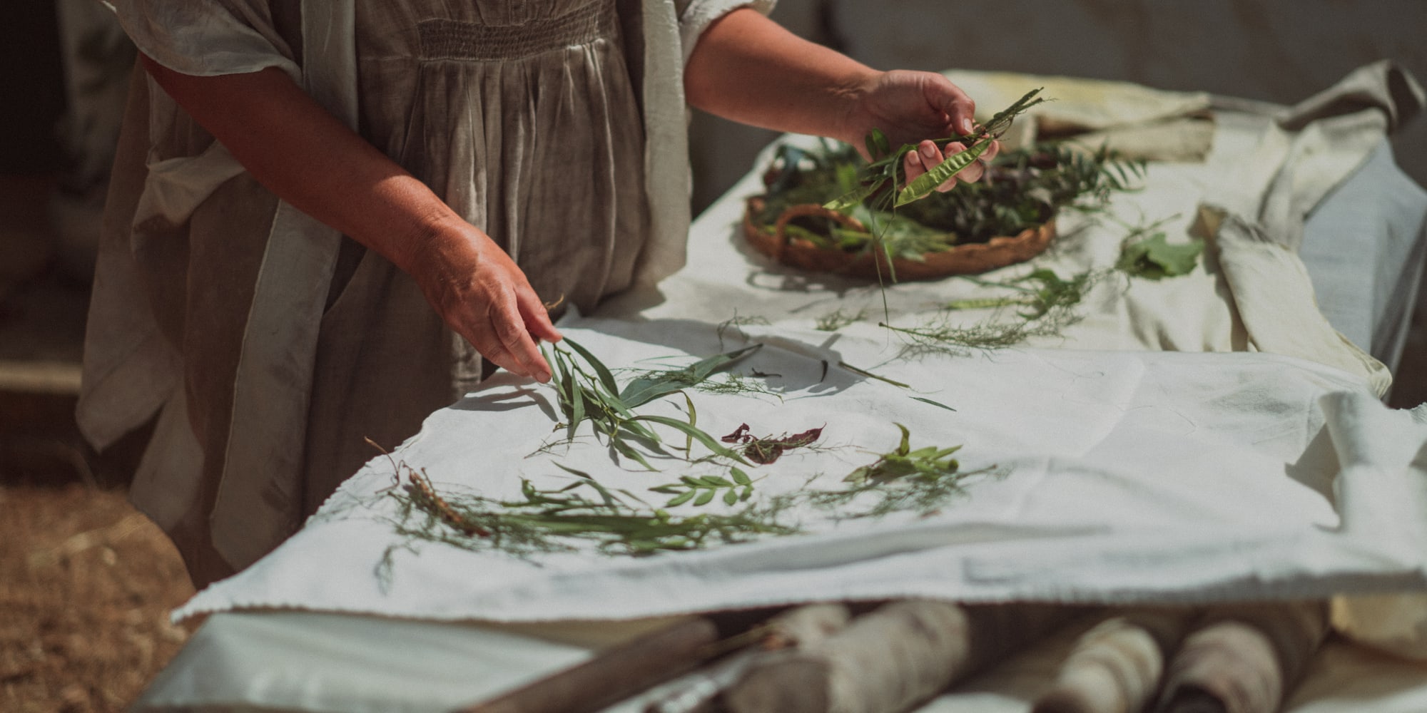 a person holding leaves on a table