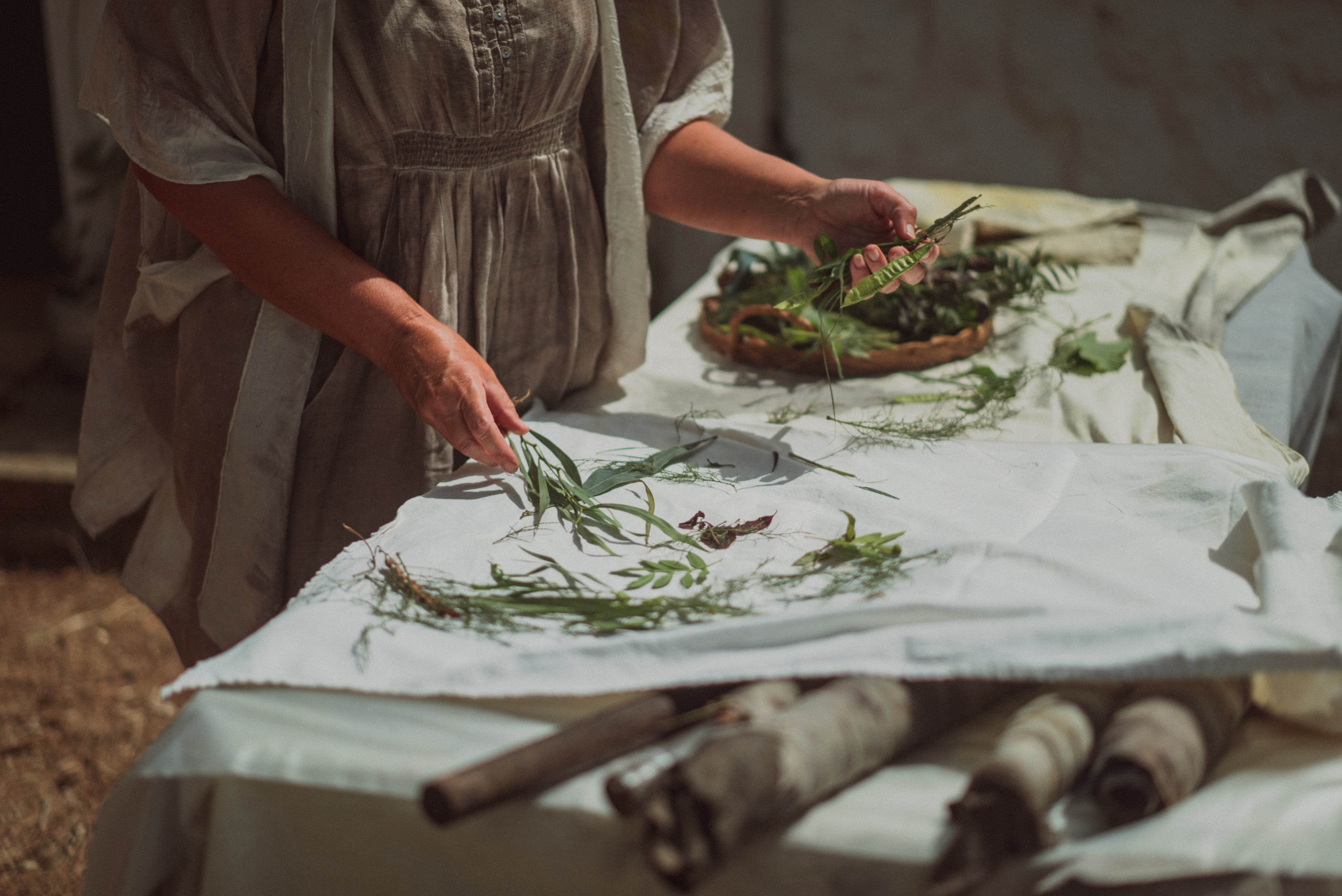 a person holding leaves on a table