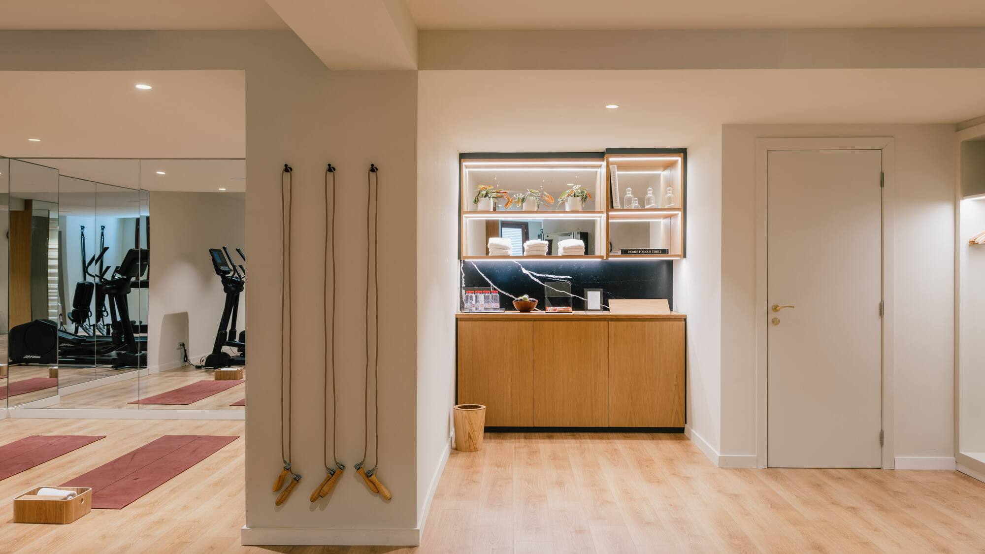 a room with a gym and exercise equipment