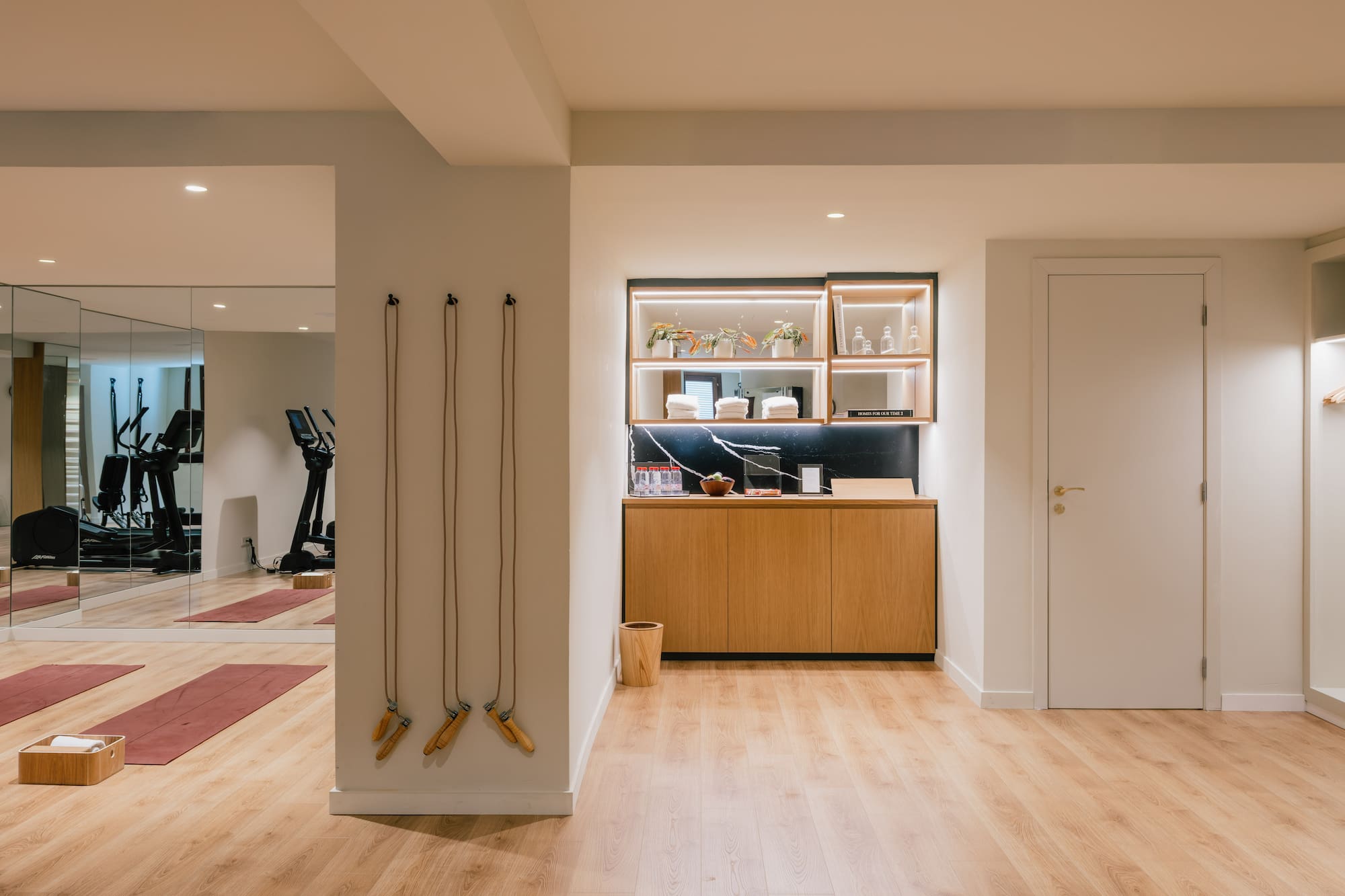 a room with a gym and exercise equipment