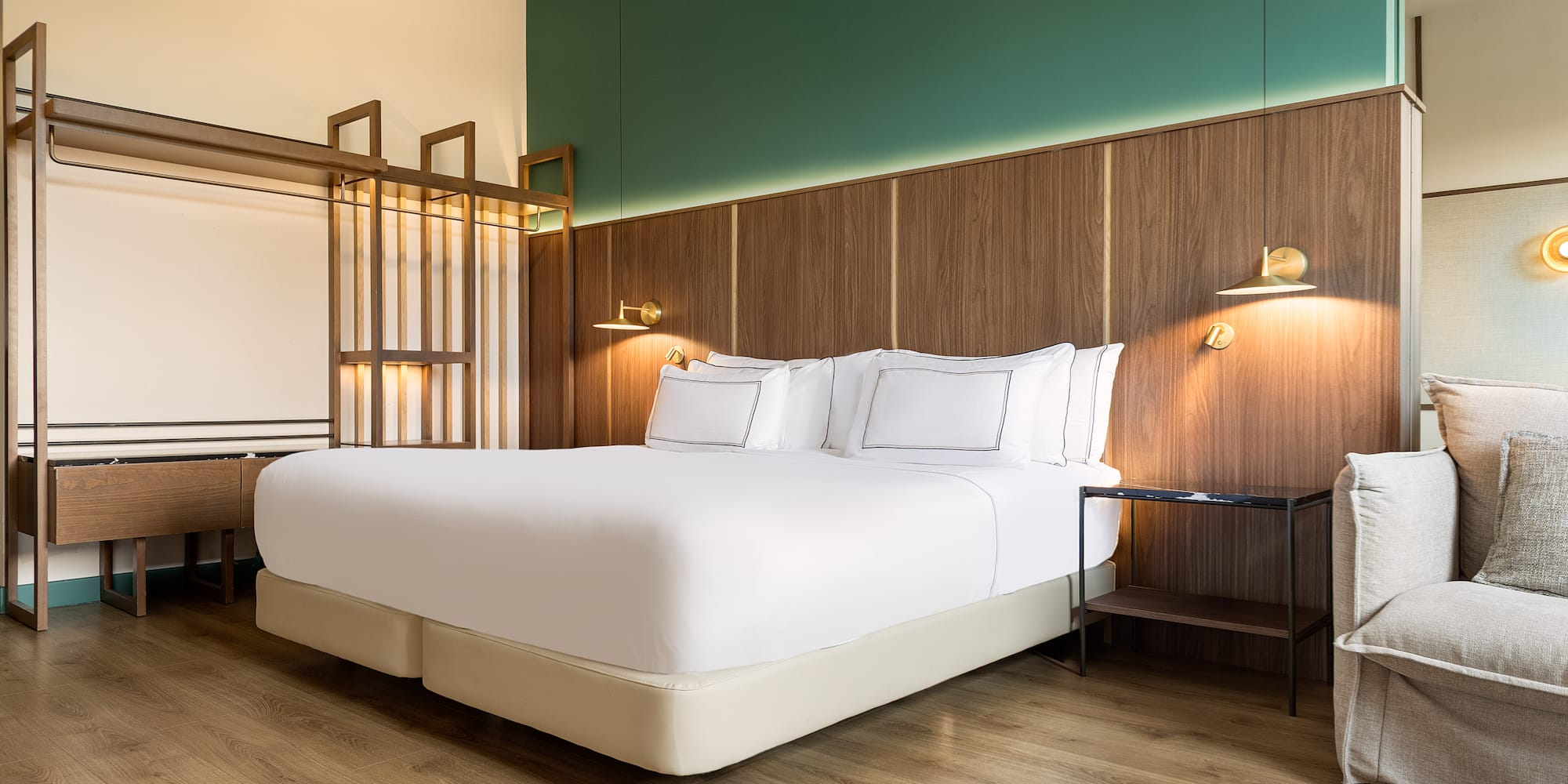 a bed with white sheets and a wood floor