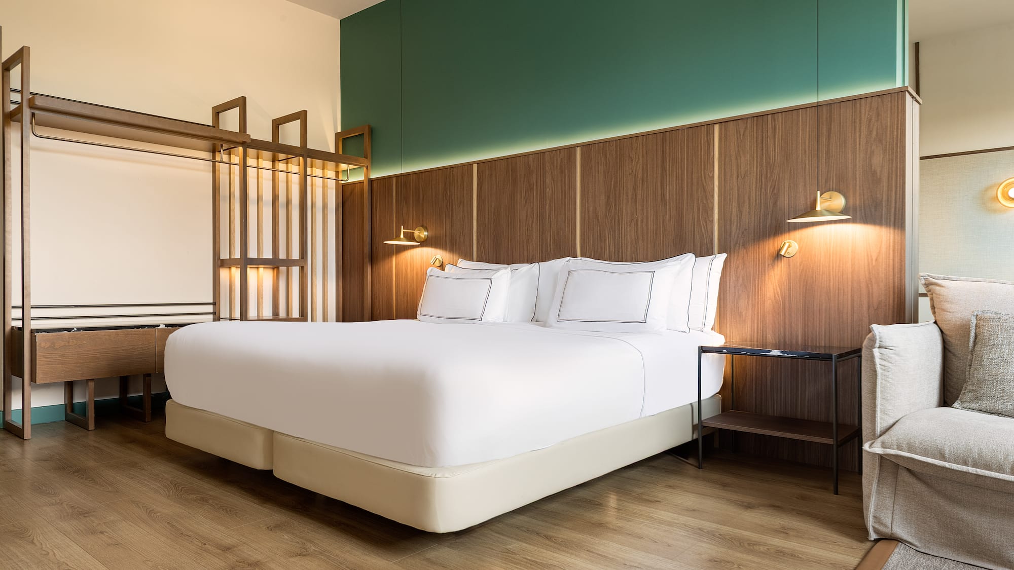 a bed with white sheets and a wood floor