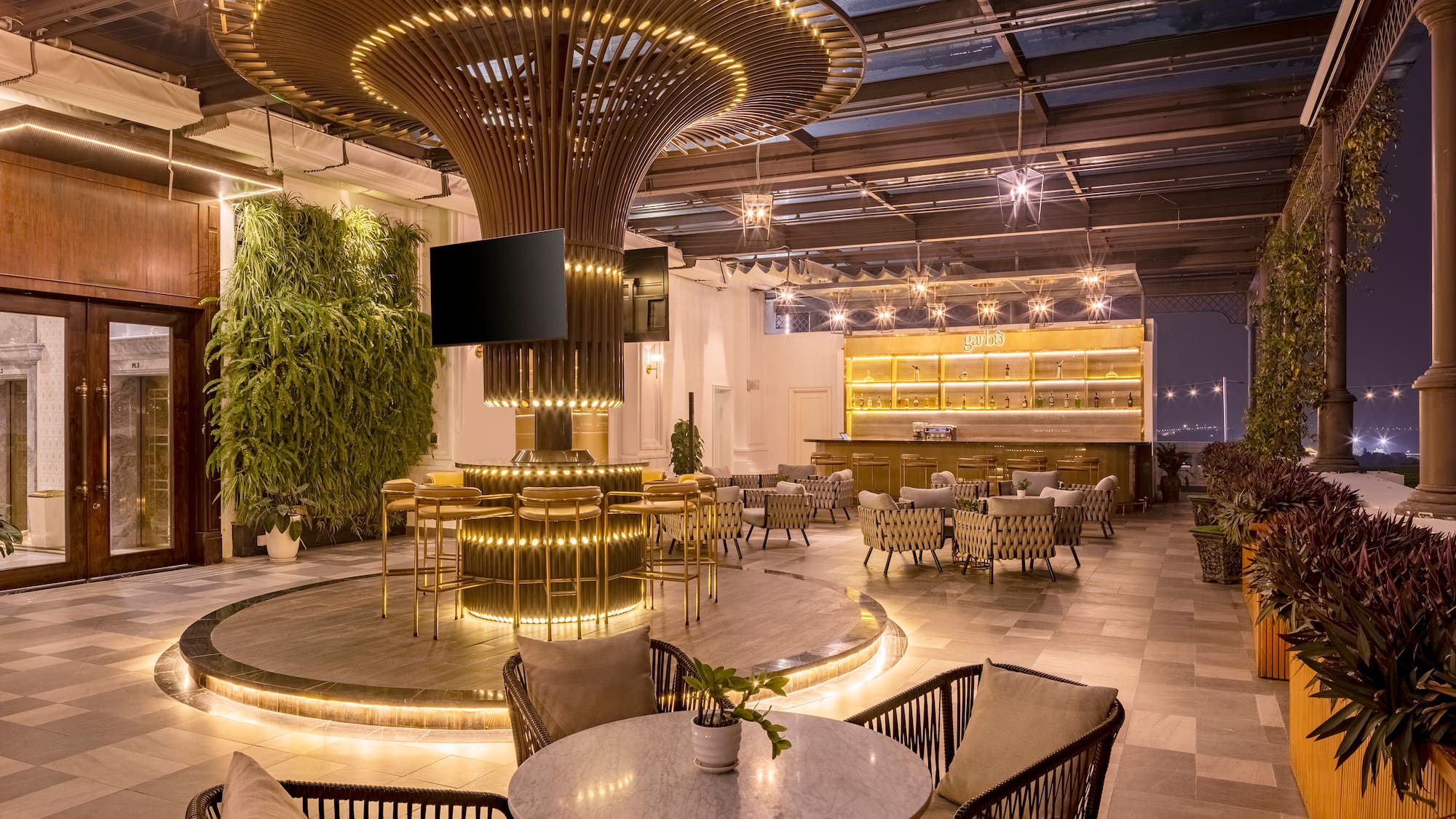 a room with a large round table and chairs