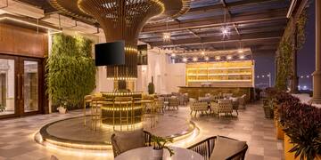 a room with a large round table and chairs