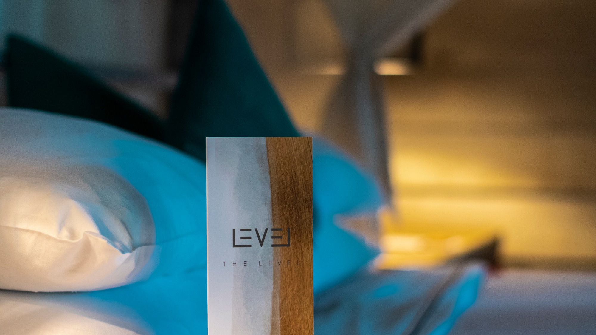Level pillow menu on a luxury hotel bed with white pillows.