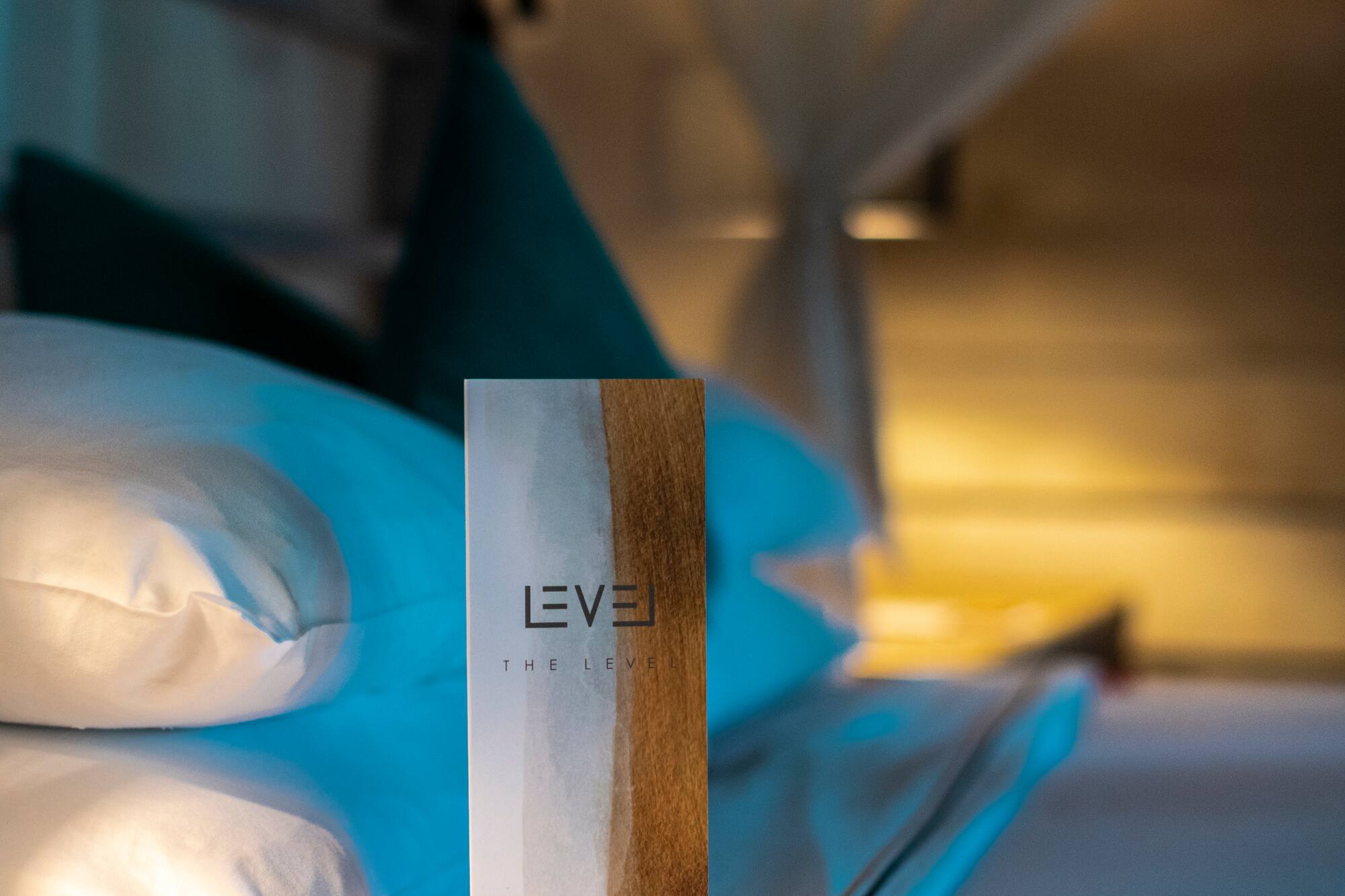 Level pillow menu on a luxury hotel bed with white pillows.