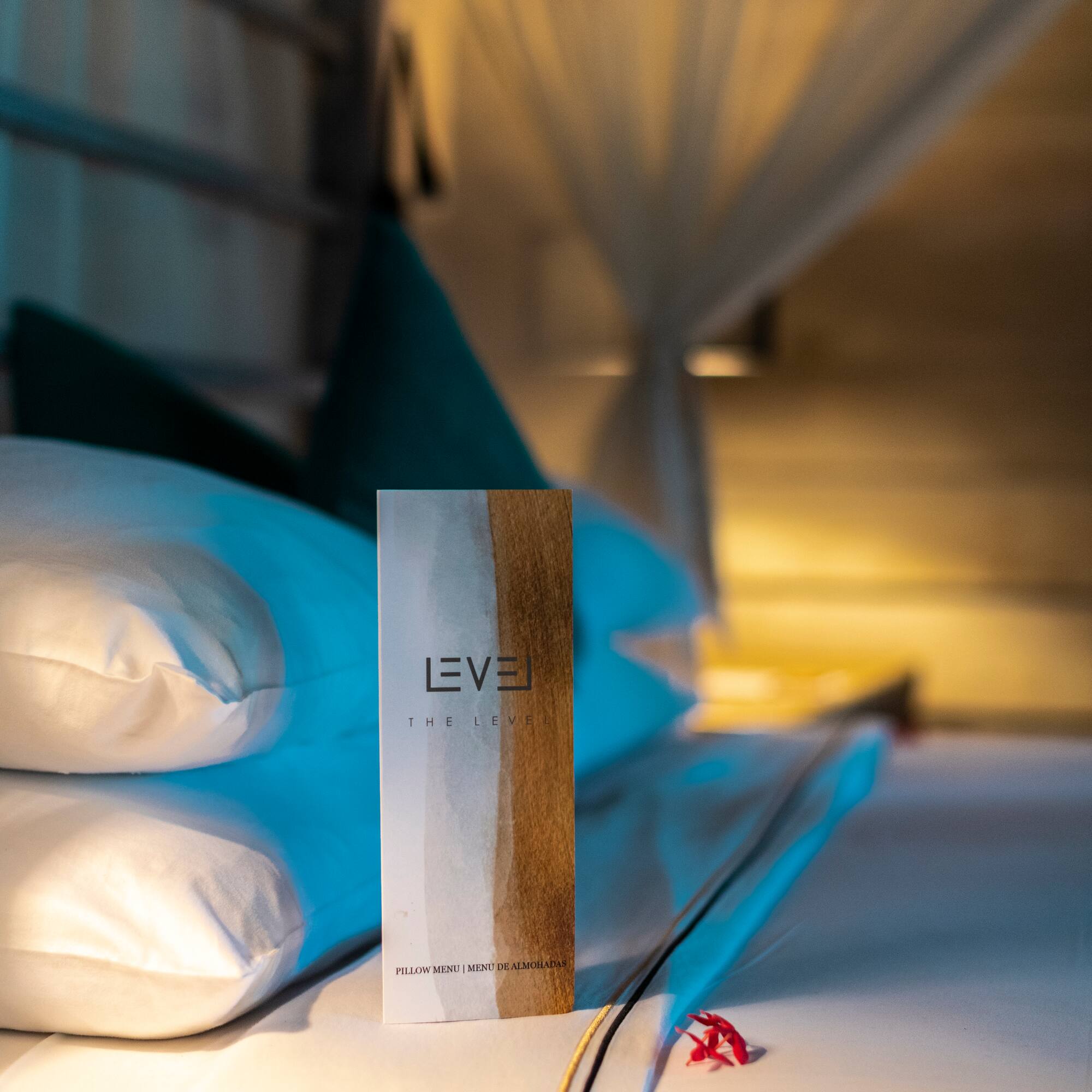 Level pillow menu on a luxury hotel bed with white pillows.