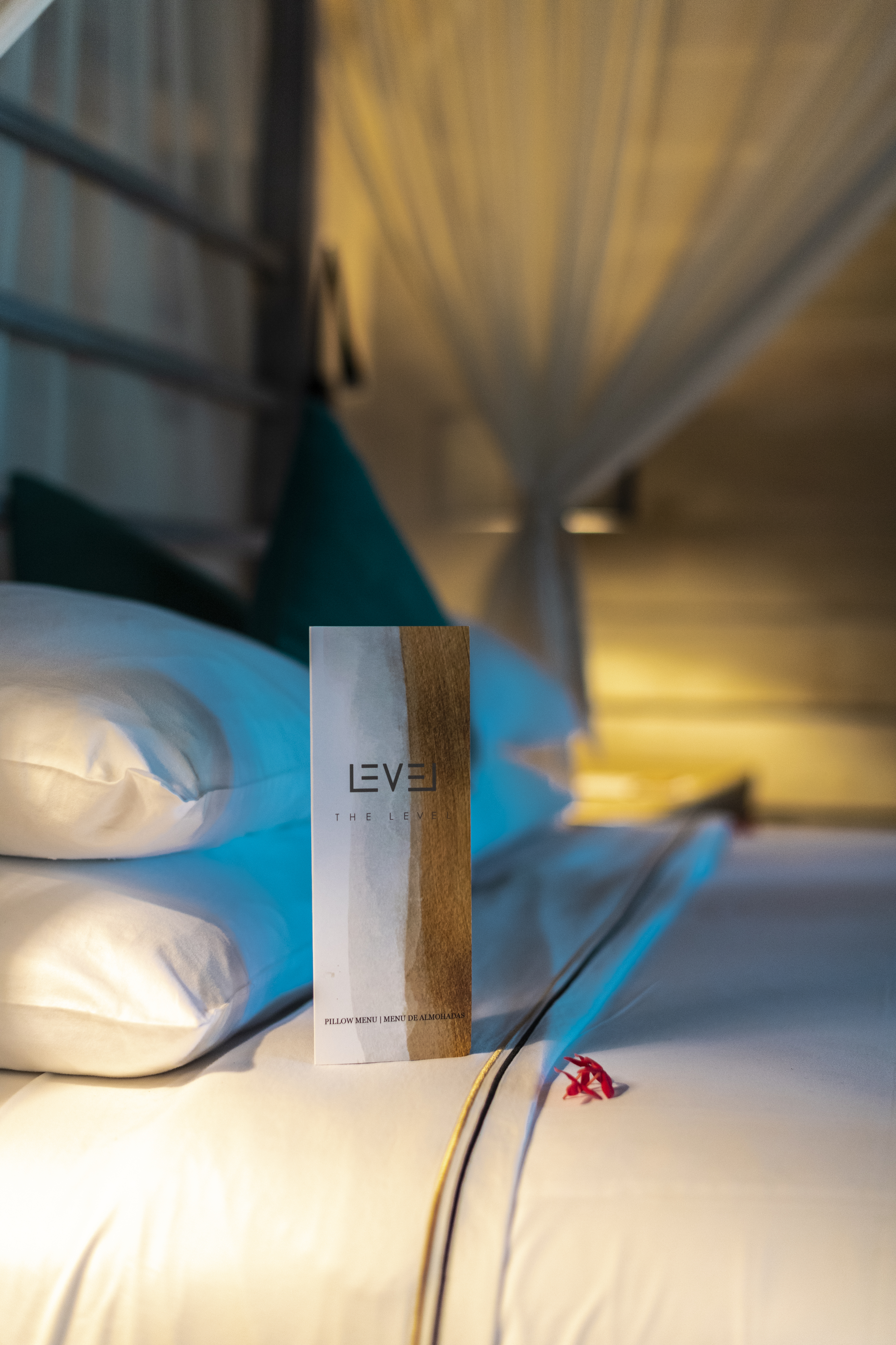 Level pillow menu on a luxury hotel bed with white pillows.