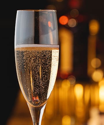 a glass of champagne with bubbles