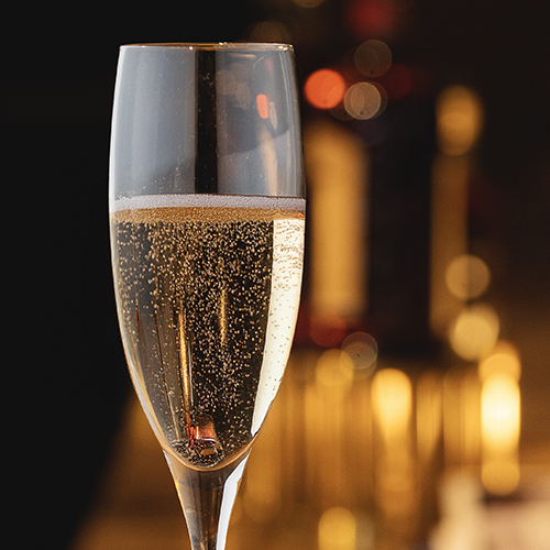 a glass of champagne with bubbles