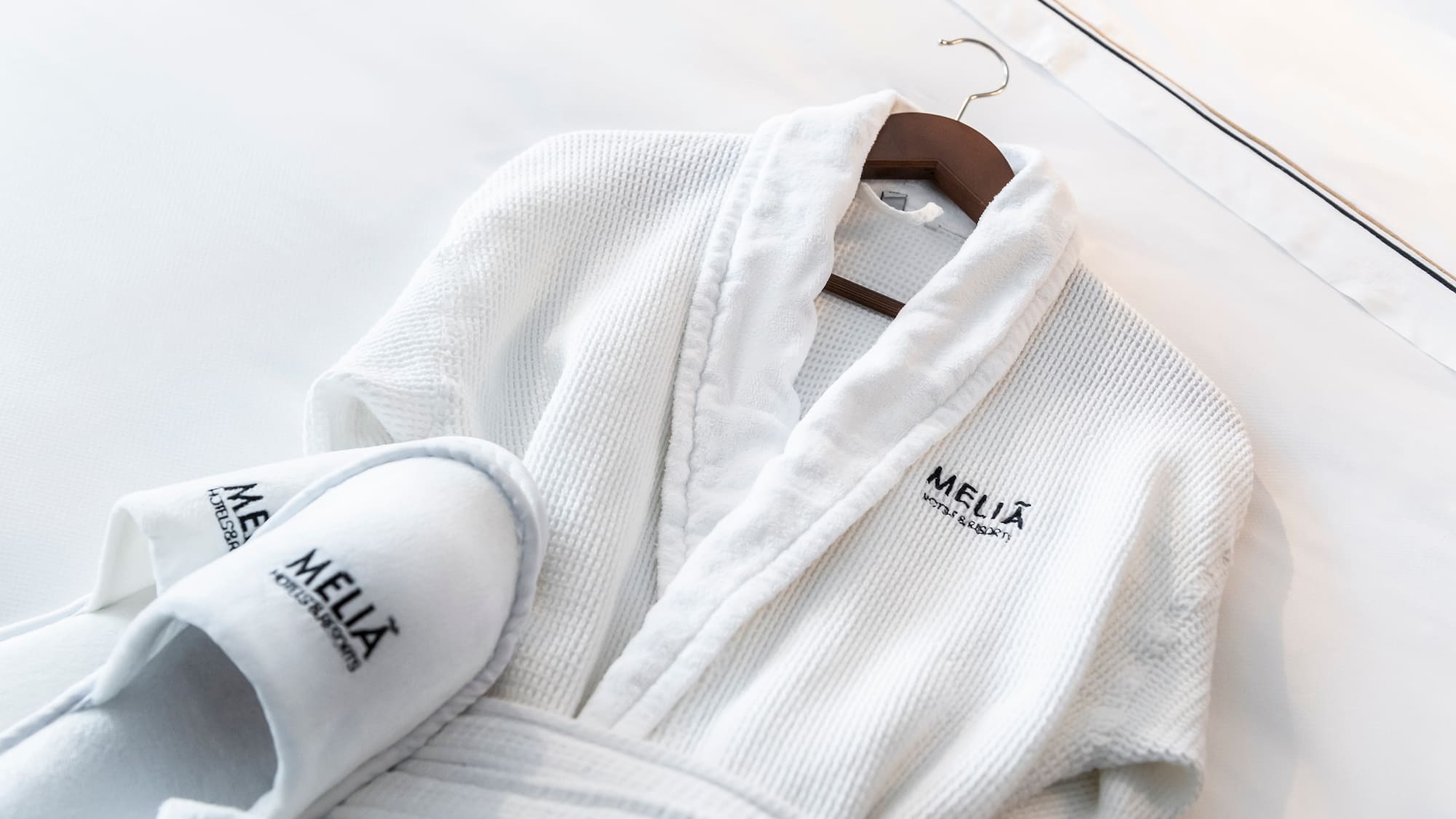 a white robe and slippers on a swinger