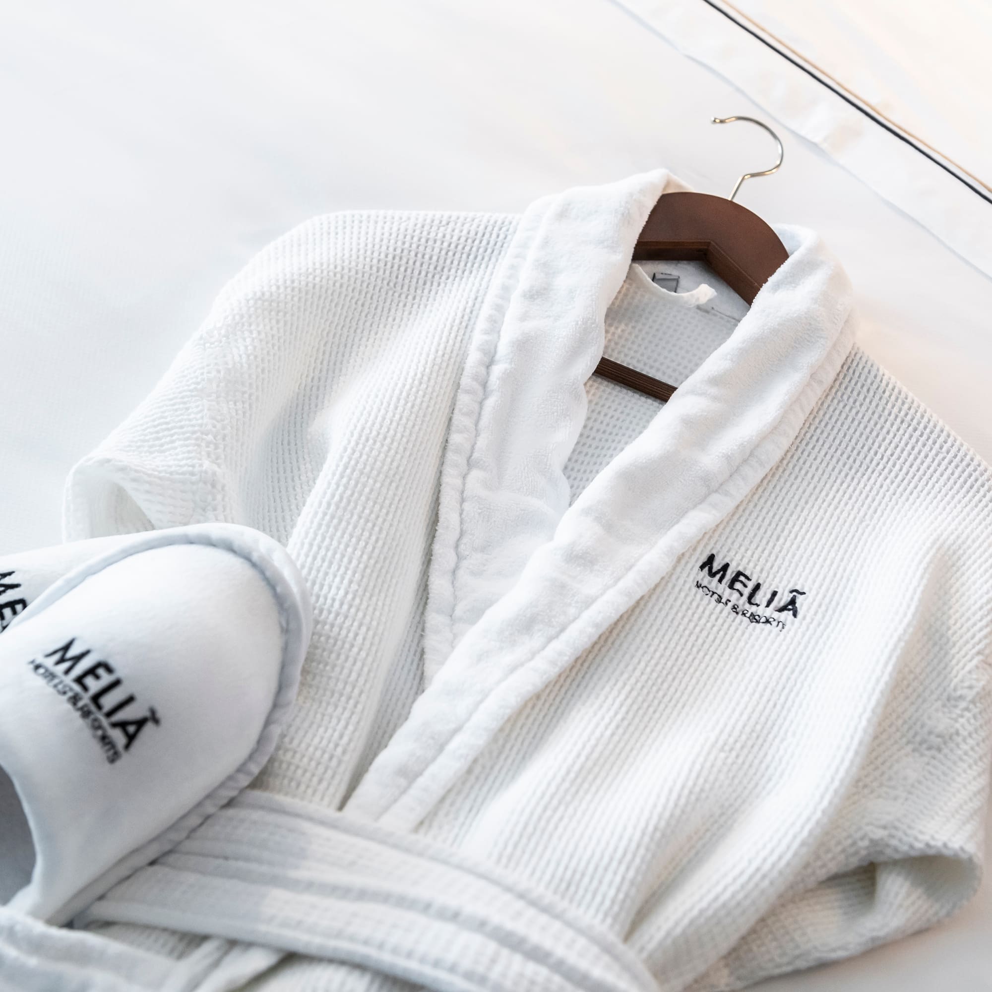 a white robe and slippers on a swinger