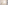 Luxury minimalist bathroom with white bathtub, plant, and bath amenities.