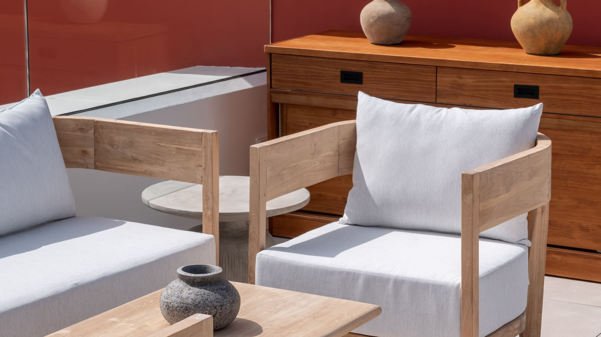 a patio with white furniture and a table