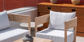 a patio with white furniture and a table