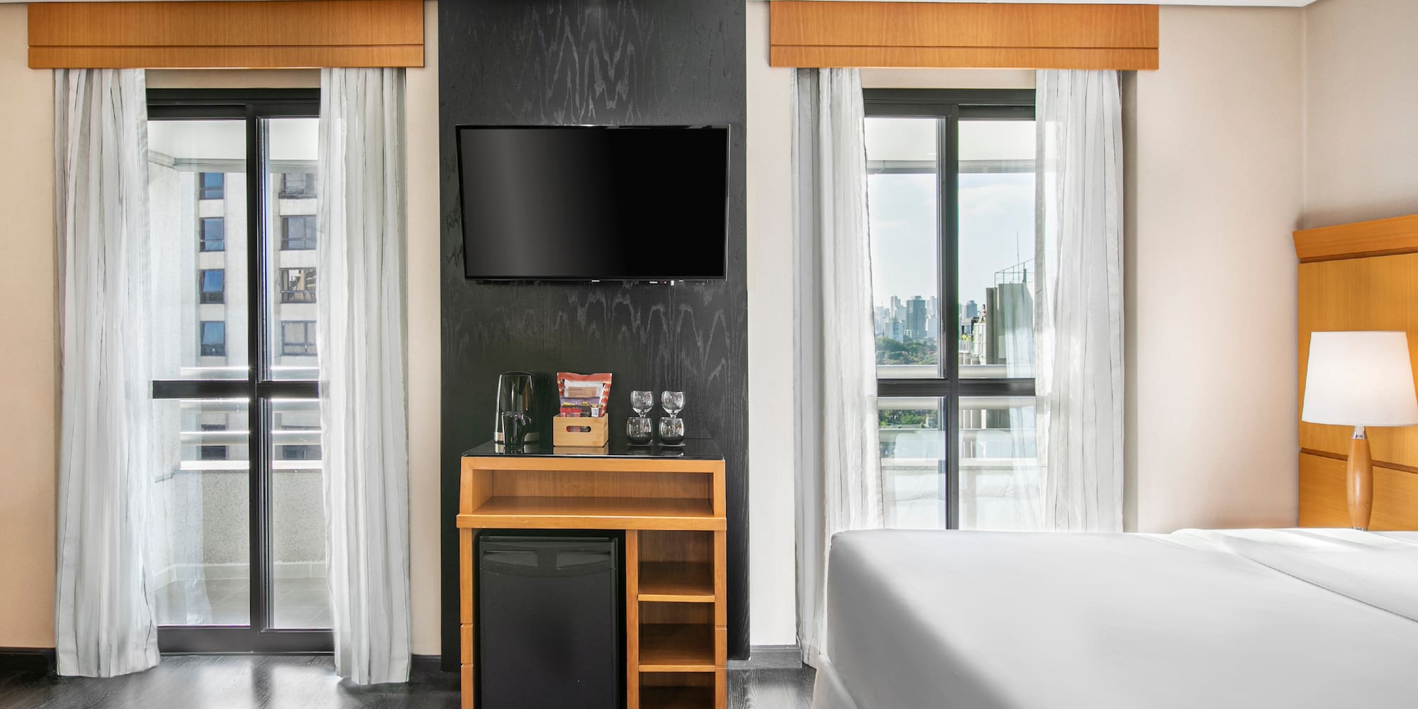 a room with a tv and a small refrigerator