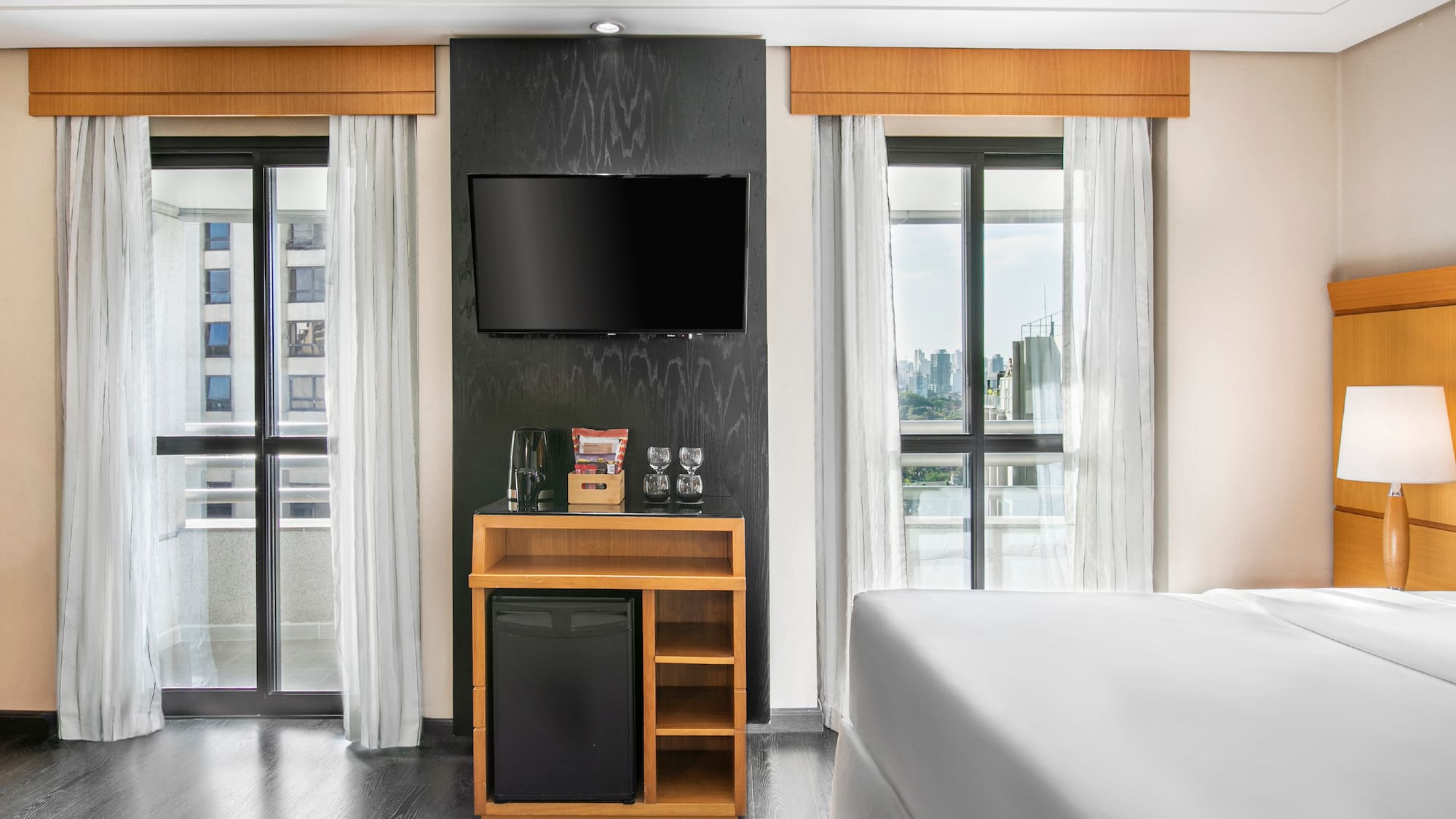 a room with a tv and a small refrigerator