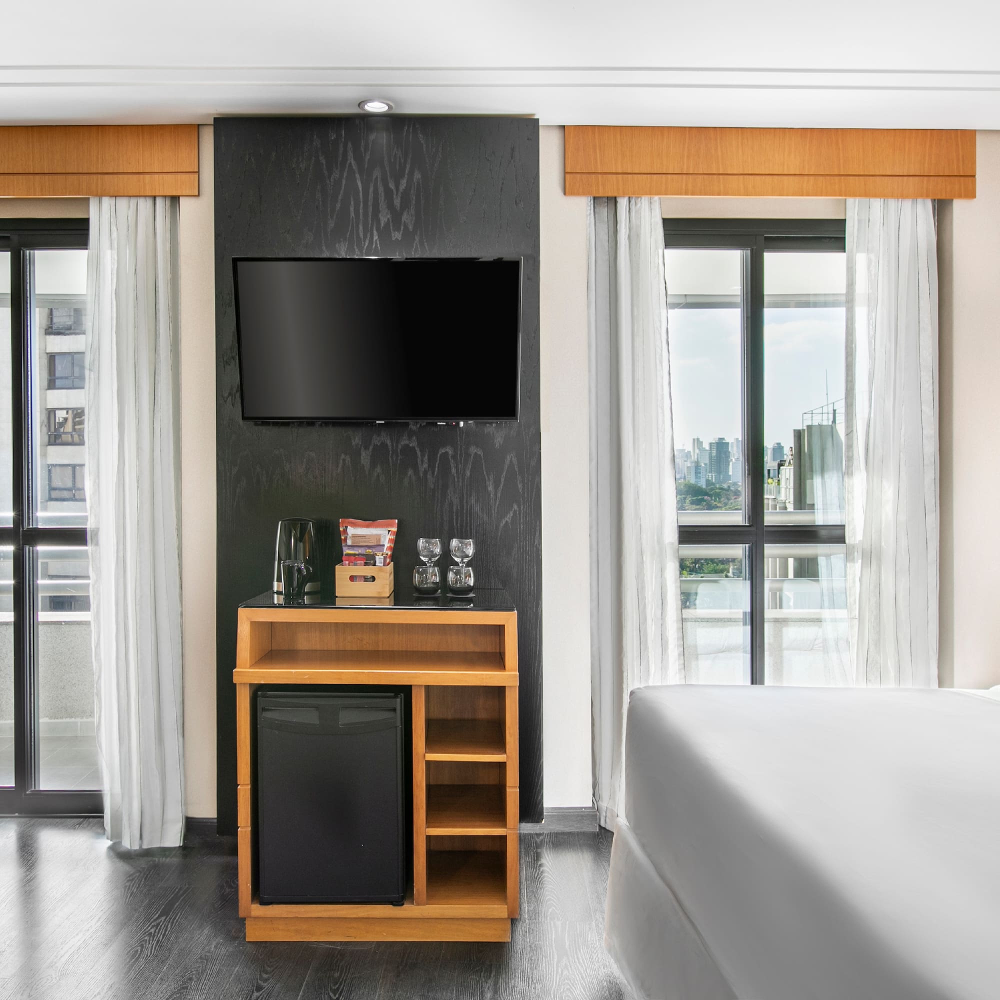 a room with a tv and a small refrigerator