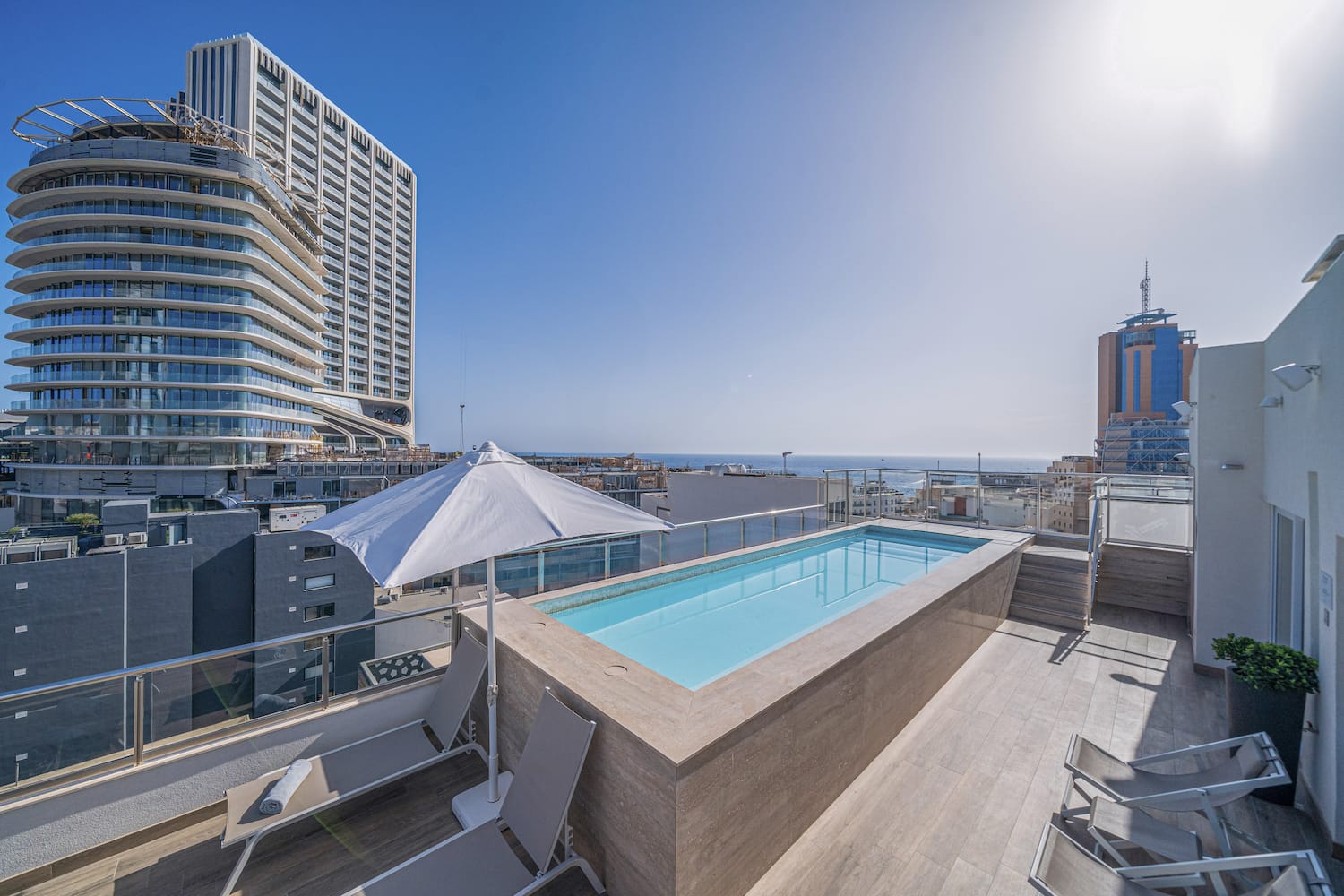 a pool on a rooftop overlooking a city
