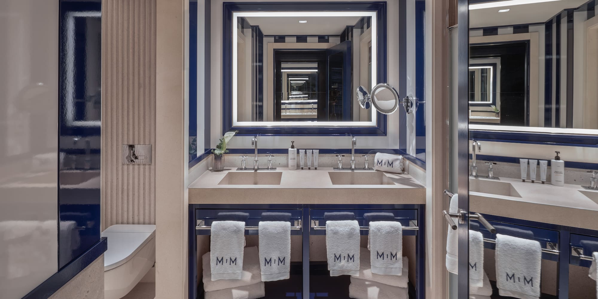 a bathroom with blue and white striped walls