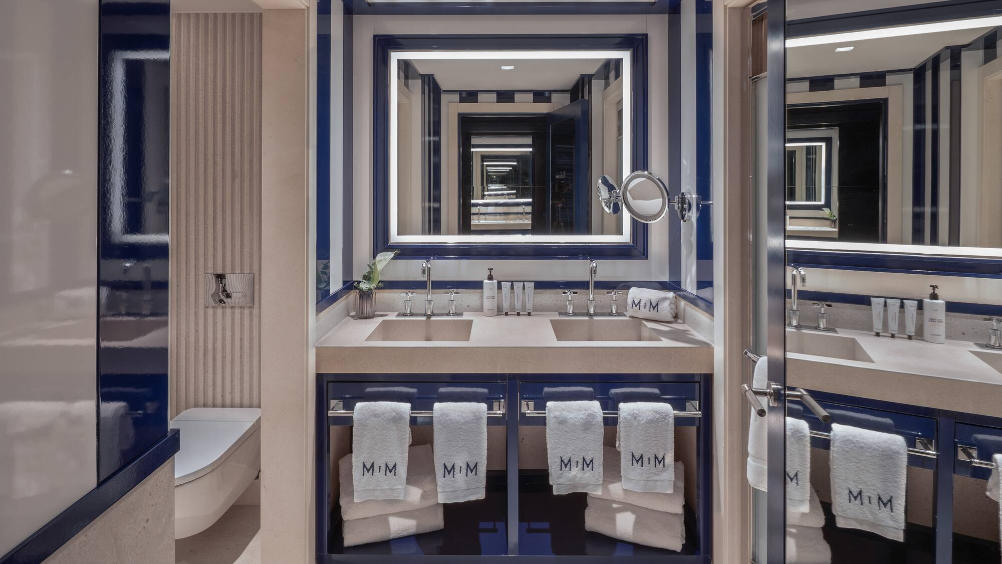 a bathroom with blue and white striped walls