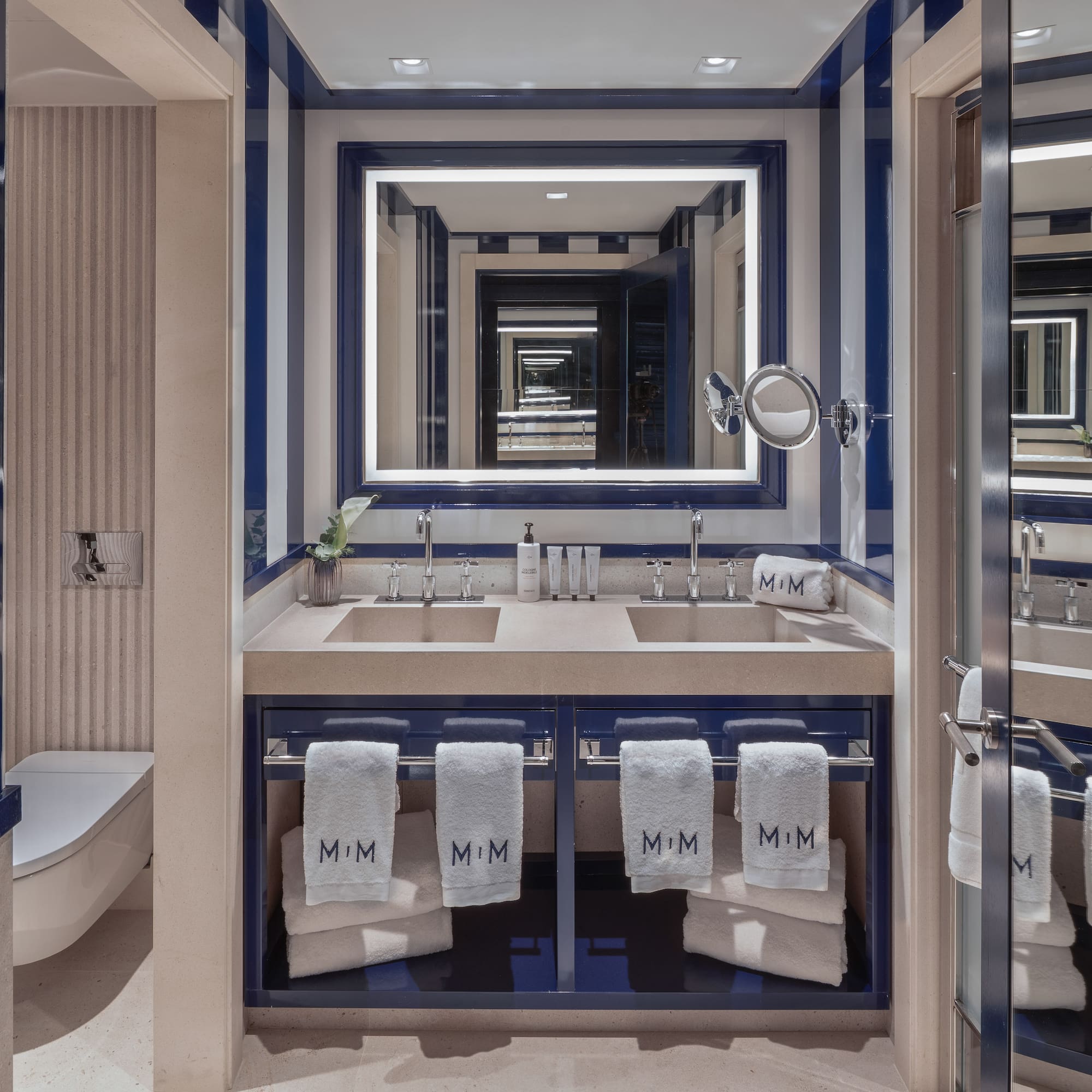a bathroom with blue and white striped walls