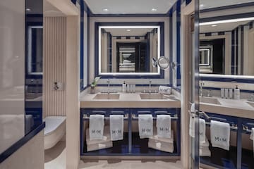 a bathroom with blue and white striped walls