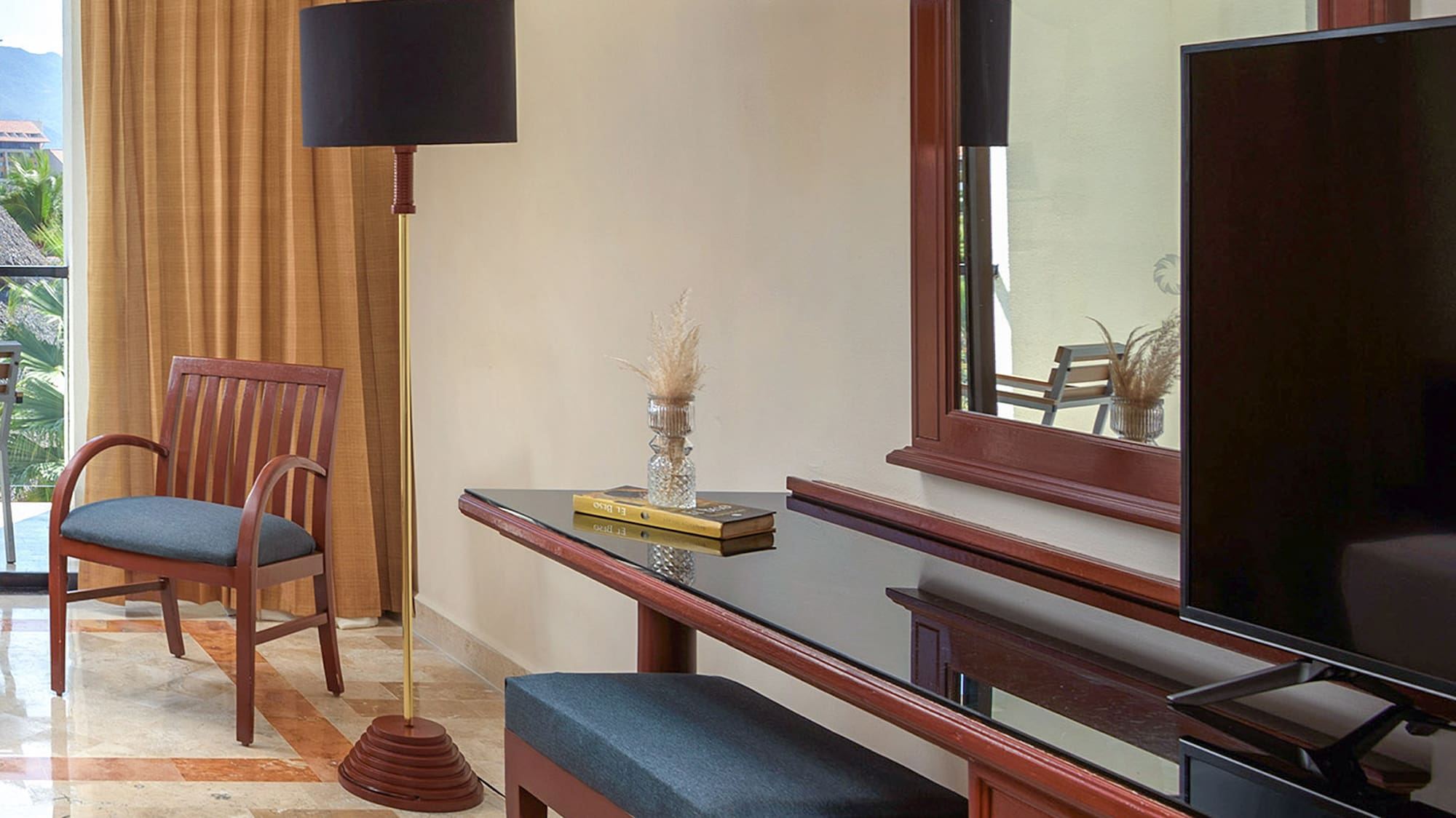 a room with a mirror and a television