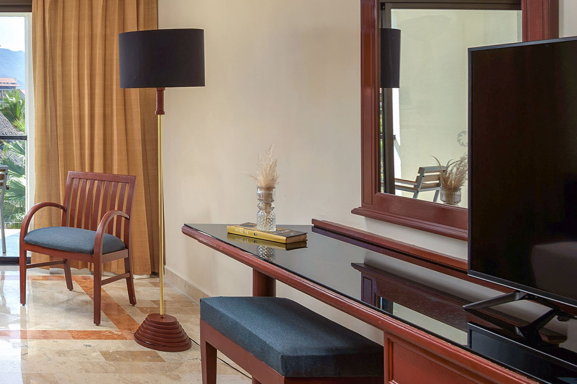 a room with a mirror and a television