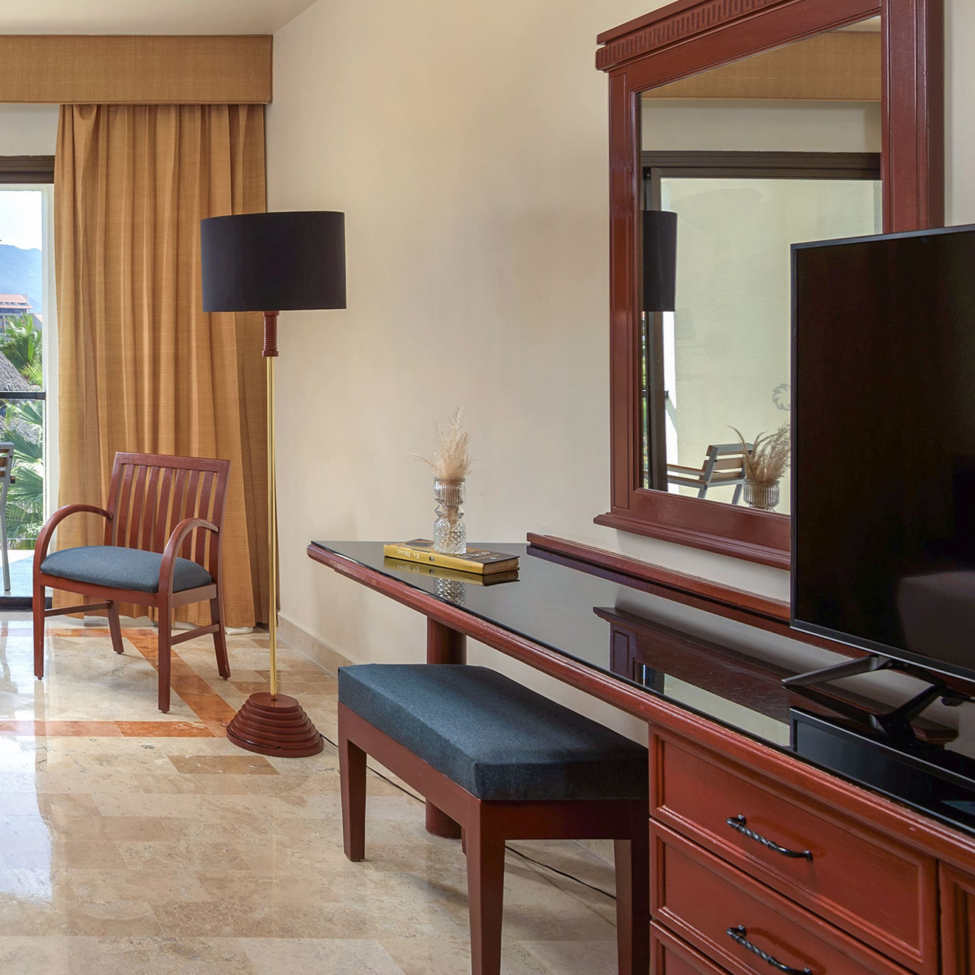 a room with a mirror and a television