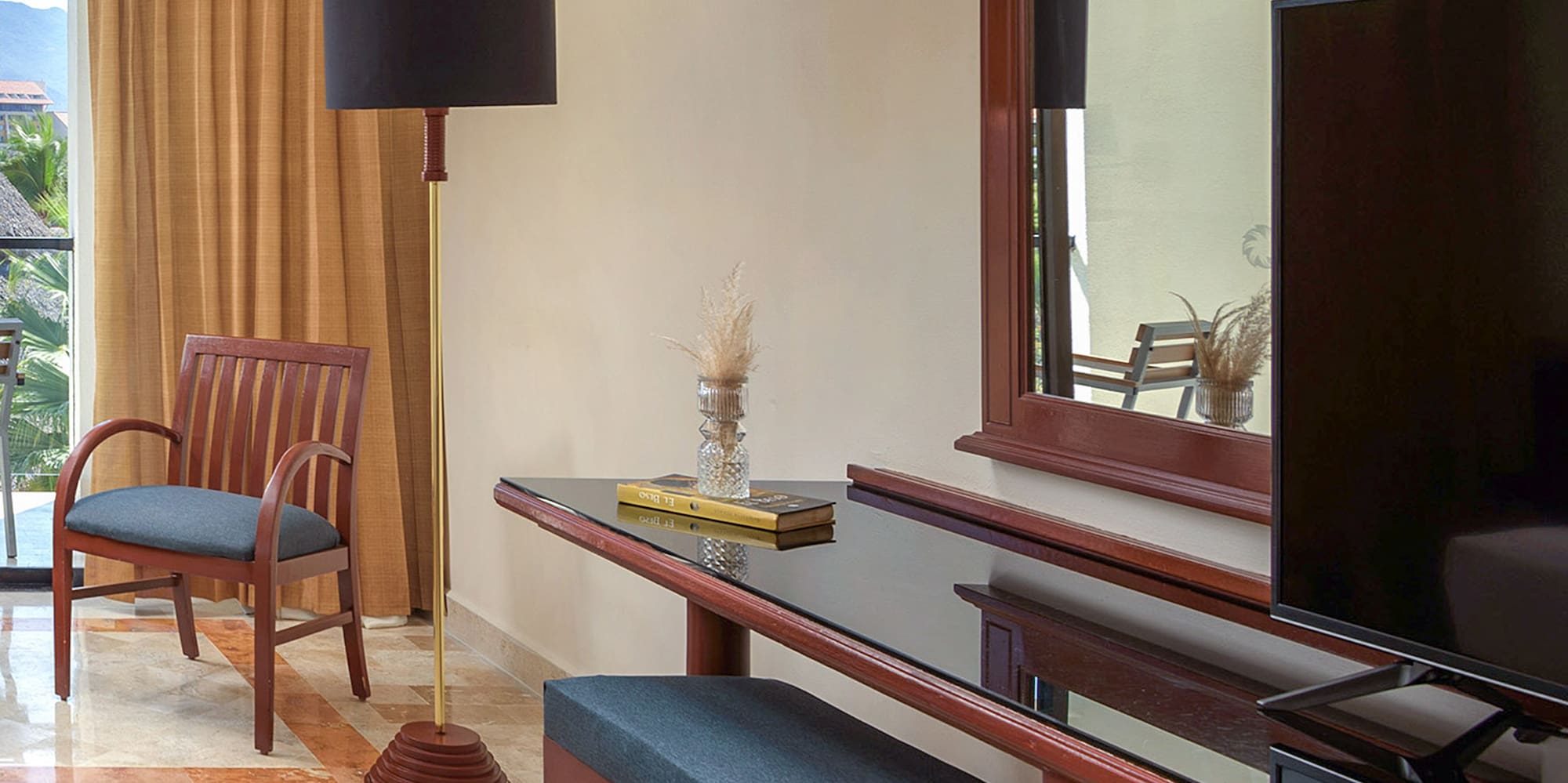 a room with a mirror and a television