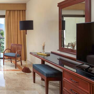 a room with a mirror and a television