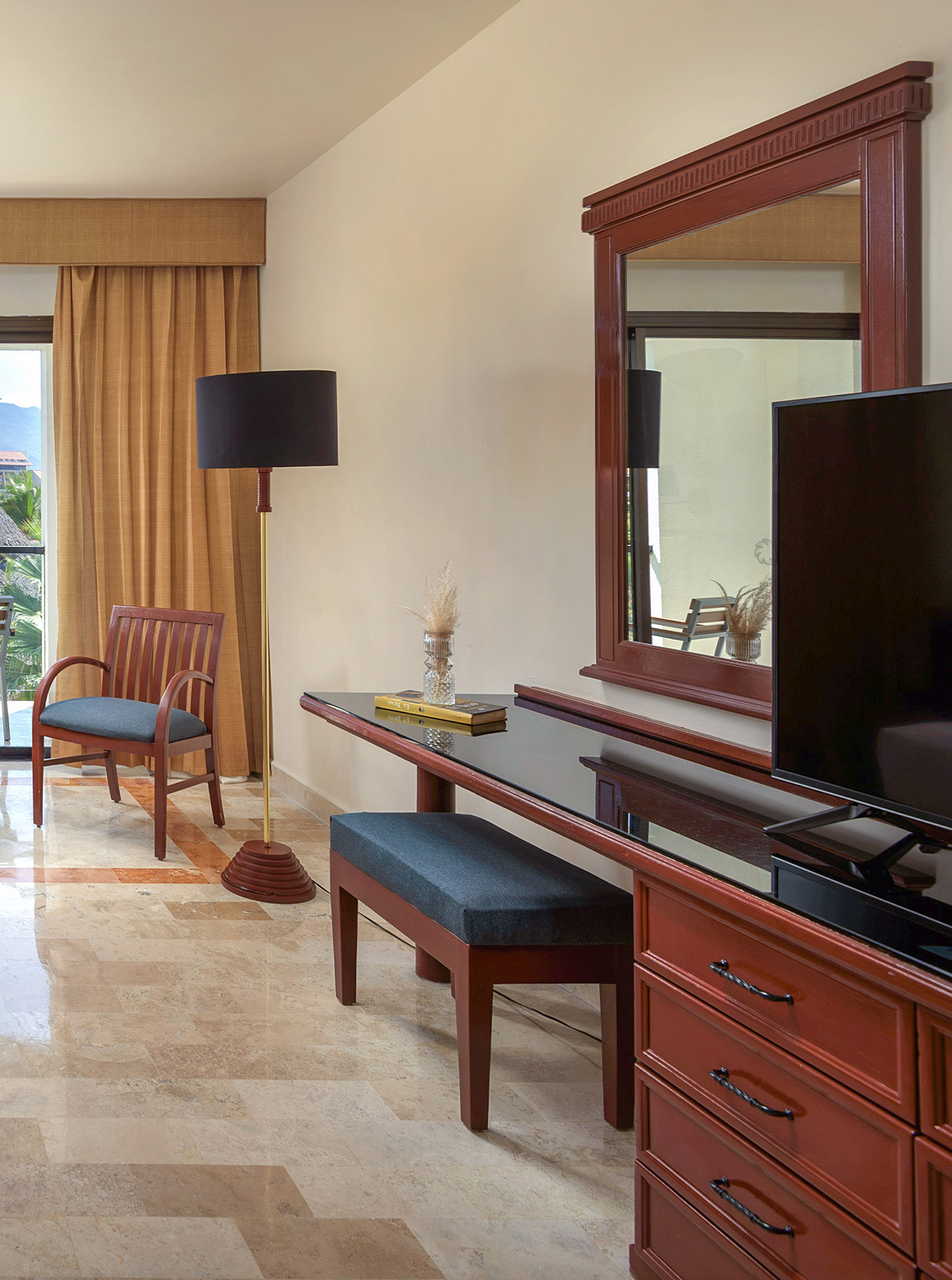 a room with a mirror and a television