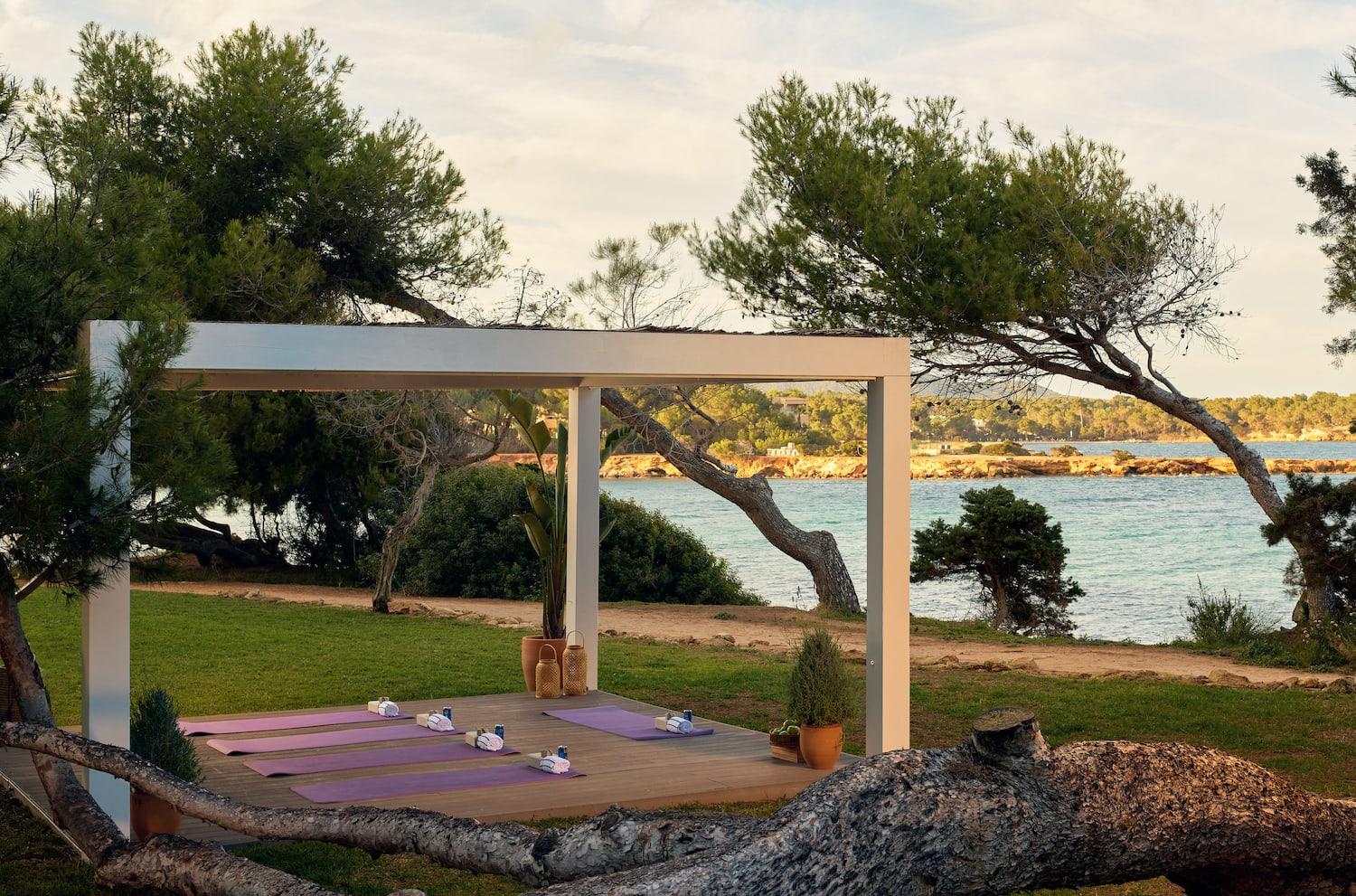 yoga mats on a deck near a body of water