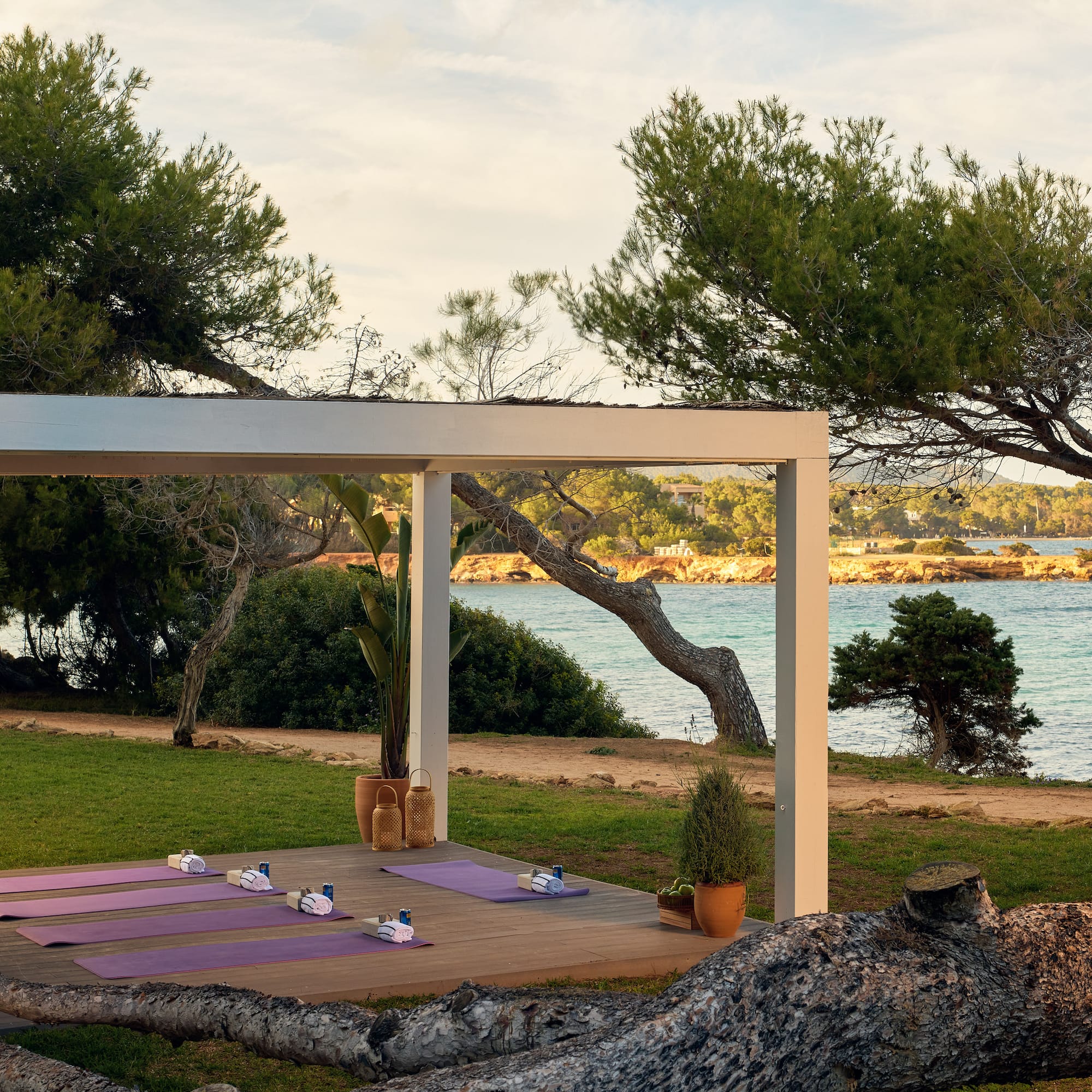 yoga mats on a deck near a body of water
