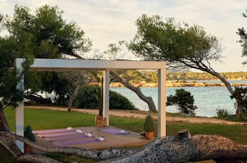 yoga mats on a deck near a body of water