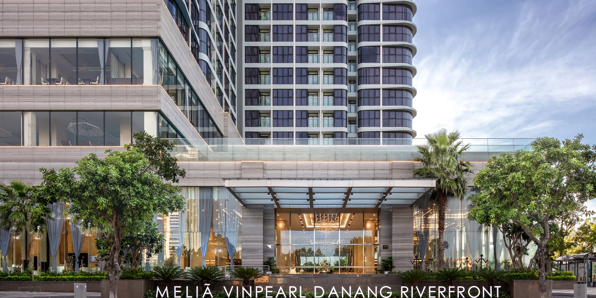 a building with trees and a sign